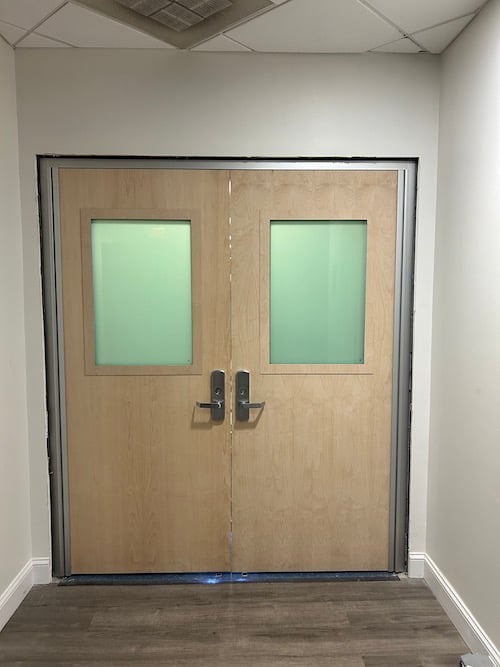 A photo of level 8 bullet-resistance glass used within wood doors to provide the highest protection in a church setting