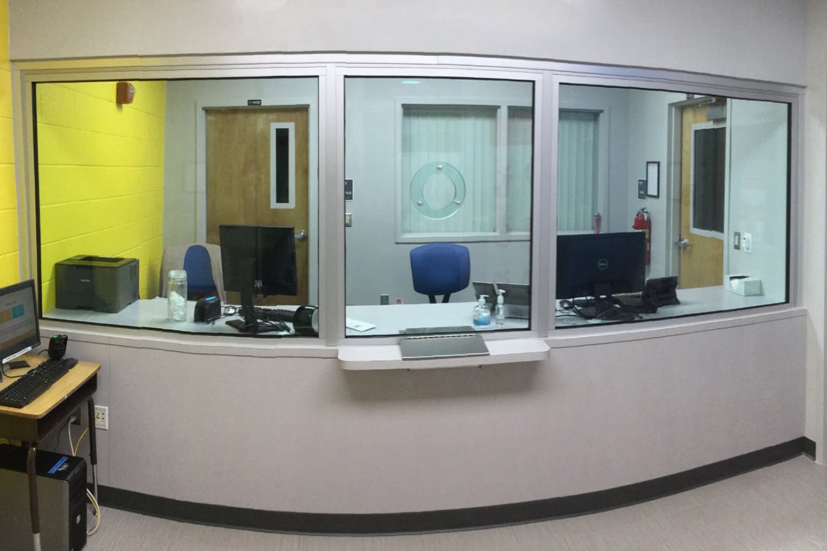 A photo of bullet-resistant transaction windows used in a school setting, which can minimize threats in conjunction with active shooter drills and reaction plans