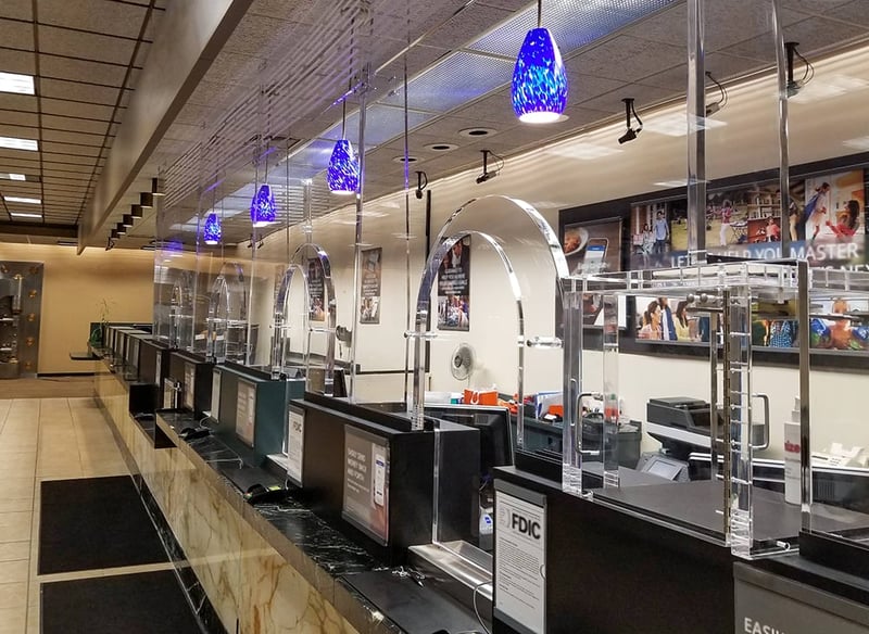 A photo showing bulletproof accessories in a financial institution that support secure transactions and help keep employees safe while providing them with a clear view and the ability to hear customers