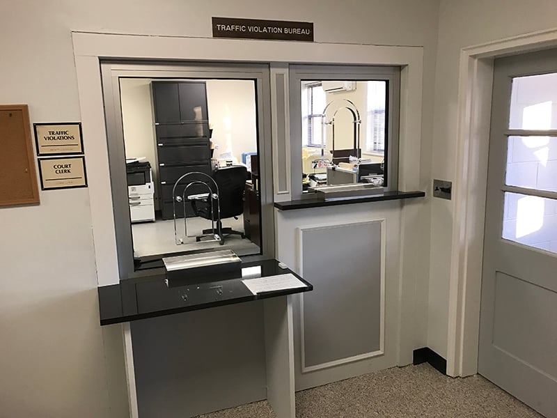 An image showcasing the use of plexiglass for bullet resistance versus traditional glass for better shatterproof properties