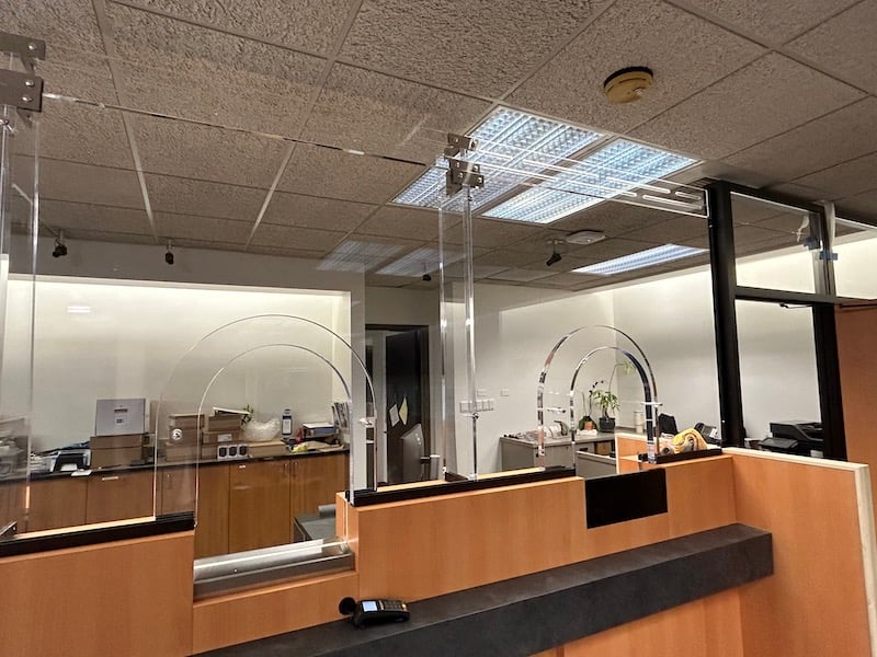 An image showcasing the use of bullet-resistant glass versus regular glass in a bank for superior protection