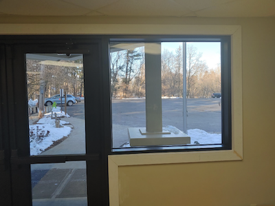 A school in an area that deals with heavy snowfall is one example of where the ASTM E1300 standard may be applicable to verify the design load