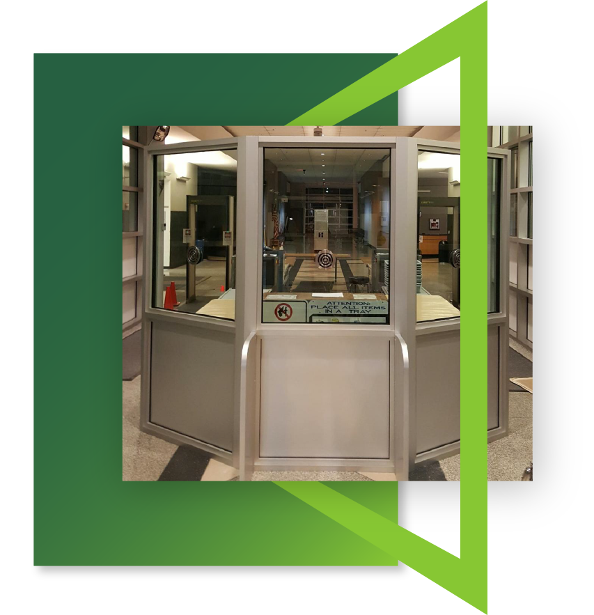 A bulletproof guard booth located inside a building to protect security staff