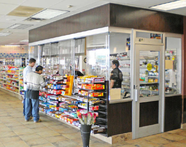 A photo showcasing a bullet-resisting barrier or bullet proof glass versus standard glass added to a convenience store